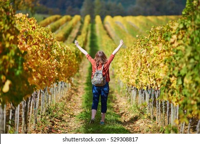 Woman tourist walking in Tuscan vineyards in Val d'Orcia, Tuscany, Italy