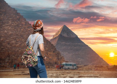 Woman tourist walks on the background of the pyramids in Giza. Egypt