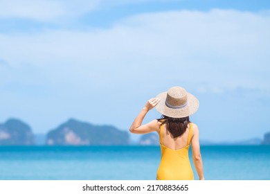 Woman tourist in yellow swimsuit and hat, happy traveler sunbathing at Paradise beach on Islands. destination, wanderlust, Asia Travel, tropical summer, vacation and holiday concept - Powered by Shutterstock