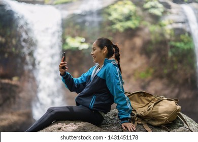 Woman Tourists Is Shooting A Waterfall She Is Video Call With Her Boyfriend.