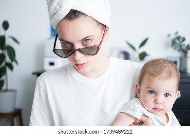 Woman With Towel Around Head In Sunglasses Holding Little Baby. Motherhood Family Lifestyle Concept. Morning Routine