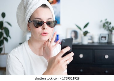 Woman With Towel Around Head In Sunglasses Holding Little Baby And Chatting, Taking Photos In Mobile Phone. Motherhood Family Lifestyle Concept. Morning Routine