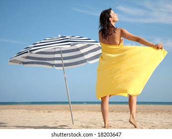 Woman With Towel On The Beach While Sunbathing