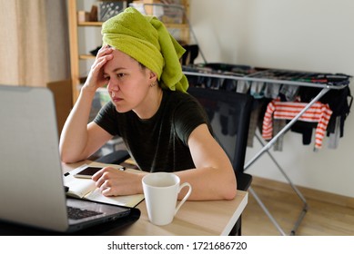 Woman With A Towel On Her Head Working On Laptop From Home. Real Life, Office In Bedroom