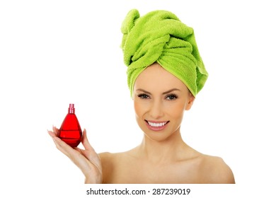 Woman In Towel Turban With Bottle Of Parfume.