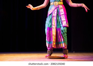 Woman traditional Dancer performing Bharatanatyam.Kuchipudi dancer balancing herself on the rim of a brass plate