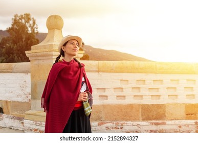 Woman In Traditional Peasant Dress Standing On A Colonial Bridge Enjoying The Sunset