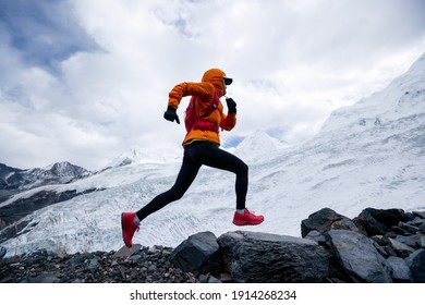 Woman Trail Runner Cross Country Running Up To Winter Snow Mountain Top