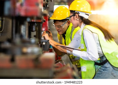 Woman Trainee And Engineer Man Wearing Safety Goggles And Hardhat Helmet Working At Metal Lathe Industrial Manufacturing Factory.