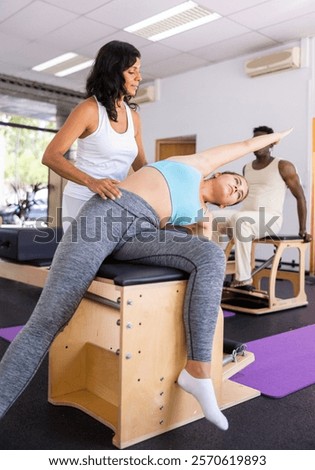 Similar – Image, Stock Photo Young woman trainer teaching the different exercises to a student while they exercise with a smile.