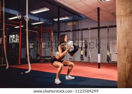 Woman training with functional gymnastic ball in the gym