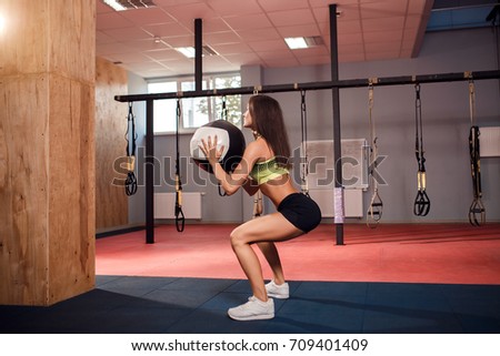 Woman training with functional gymnastic in the crossfit gym