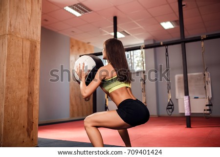 Woman training with functional gymnastic in the crossfit gym