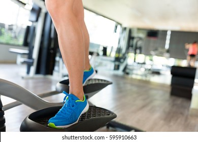 Woman Training On Elliptical Machine 