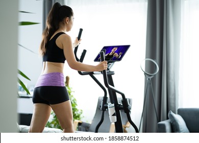 Woman Training On Elliptical Trainer Online At Home