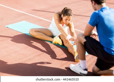 Woman Training With Personal Trainer Outdoor