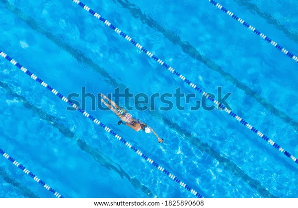 Woman training in\
swimming pool, top view