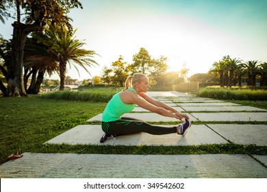 Woman Training In Urban Park At Sunset (intentional Sun Glare)