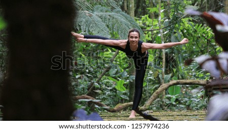 Woman training Yoga balance in nature