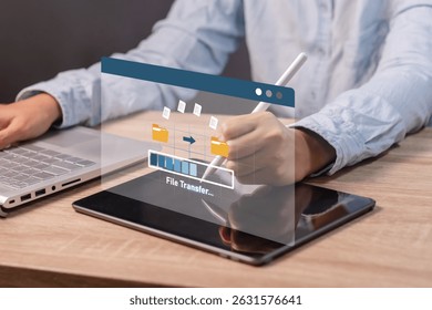 A woman transfer files from tablet computer to laptop. Backup, copy file and media or exchange data concept. 