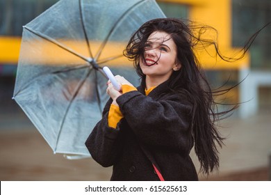 Woman With Transparent Umbrella In The Wind