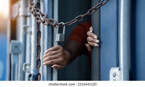 Woman trapped in cargo container ,woman immure by chain wait for Human Trafficking or foreign workers, Woman holding master key wait for holp help Refugee
 - Shutterstock ID 2116541120