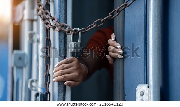Woman trapped in cargo container\
,woman immure by chain wait for Human Trafficking or foreign\
workers, Woman holding master key wait for holp help\
Refugee\
