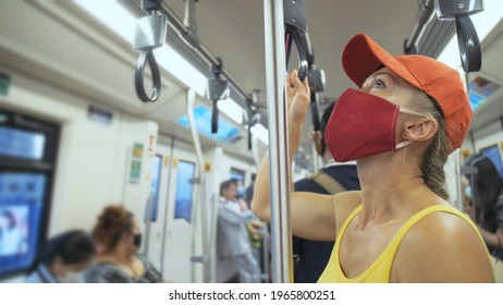 Woman travel caucasian ride at overground train airtrain with wearing protective medical mask. Girl tourist at airtrain with respirator. People mask.