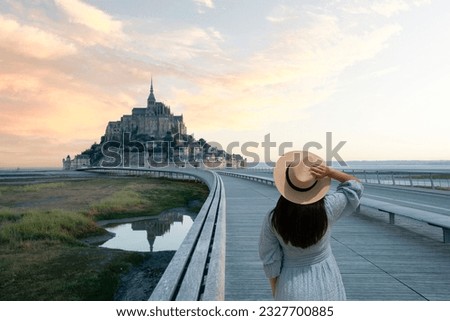 Woman is travel at Mont Saint Michel during summer time in Normandy, France.