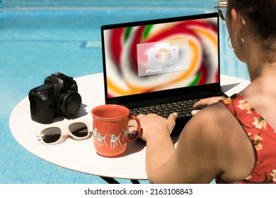 Woman Travel Photography Downloading Images On The Laptop To Upload To The Cloud. Travel Photographer Creating Photographic Content For Networks Working .  Woman Travel Photography Concept