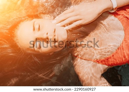 Similar – Woman face lying down over hands with colorful sparkles in skin