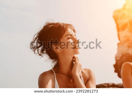 Woman travel sea. Happy tourist enjoy taking picture outdoors for memories. Woman traveler posing on the beach at sea surrounded by volcanic mountains, sharing travel adventure journey
