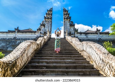 Woman traveler at Ancient gate at Pura Penataran Agung Lempuyang temple on Bali, Indonesia