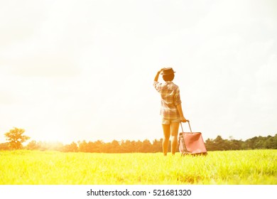 woman traveler with backpack and hat walking in amazing meadows and forest, wanderlust travel concept