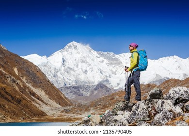 Woman Traveler With Backpack Hiking In Mountains With Beautiful Summer Himalayas Landscape On Background. Everest Base Camp Trek. Cho Oyu Mountain On The Background