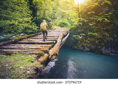 Woman Traveler With Backpack Hiking On Bridge Over River Travel Lifestyle Concept Forest On Background Summer Journey Vacations Outdoor