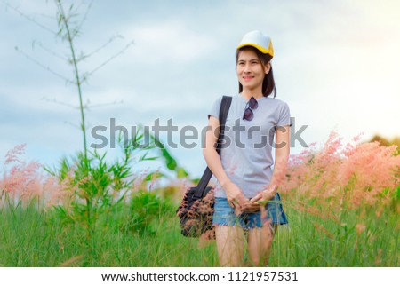woman traveler with backpack looking at amazing mountains and forest