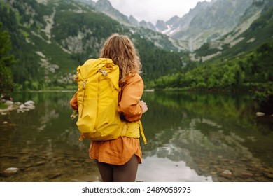 Woman - traveler with backpacks on hiking the nature. Travel, lifestyle, adventure, summer vacations. - Powered by Shutterstock