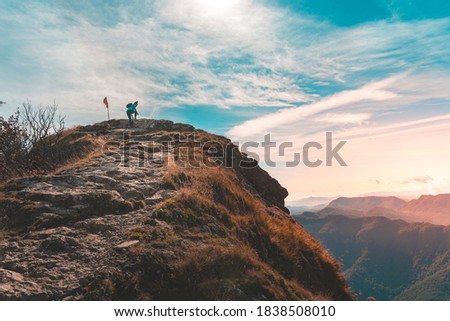 Woman traveler hiking in mountains. Adventure solo traveling lifestyle. Wanderlust adventure concept. Active weekend vacations wild nature outdoor. Autumn fall forest.