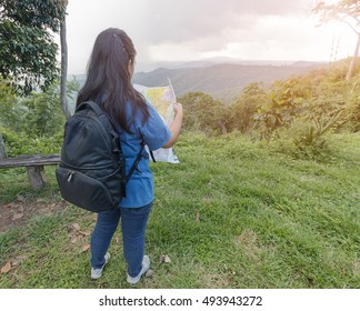Woman traveler holding a map on the mountain. - Shutterstock ID 493943272