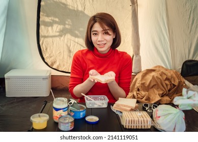 A Woman Traveler Is Preparing Sandwiches For Her Dinner Inside The Tent.