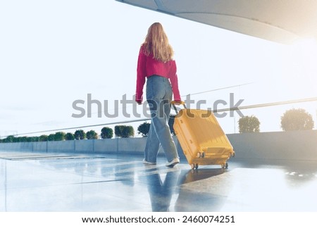 Similar – Image, Stock Photo Woman traveling with a suitcase on modern bridge