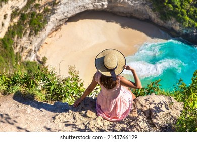Woman traveler at  viewpoint at Kelingking Beach in Nusa Penida island, Bali, Indonesia