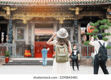 woman traveler visiting in Taiwan, Tourist with hat sightseeing in Longshan Temple, Chinese folk religious temple in Wanhua District, Taipei City. landmark and popular. Travel and Vacation concept - Shutterstock ID 2290843481