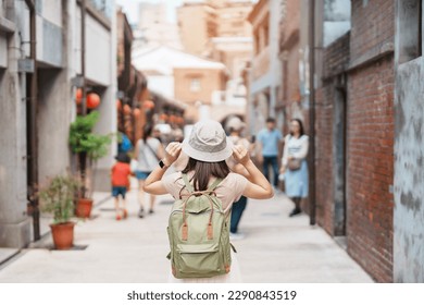 woman traveler visiting in Taiwan, Tourist with backpack and hat sightseeing in Bopiliao Historic Block, landmark and popular attractions in Taipei city. Asia Travel - Shutterstock ID 2290843519