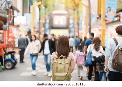 woman traveler visiting in Taiwan, Tourist with bag sightseeing and Shopping in Ximending street Market, landmark and popular attractions in Taipei city. Asia Travel and Vacation concept