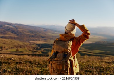 Woman Traveler In A Yellow Jacket In A Hat Backpack Travel Mountains Lifestyle