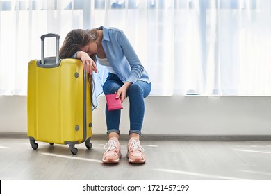 Woman Traveler With Yellow Suitcase Affected By Flight Delay And Cancelled Travel And Vacation Holiday. Travel Ban And Traveling Problems 