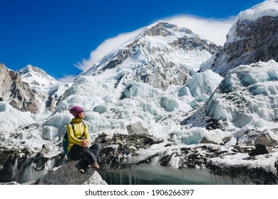 Woman Travelerh hiking in Himalaya mountains with mount Everest, Earth's highest mountain. Travel sport lifestyle concept