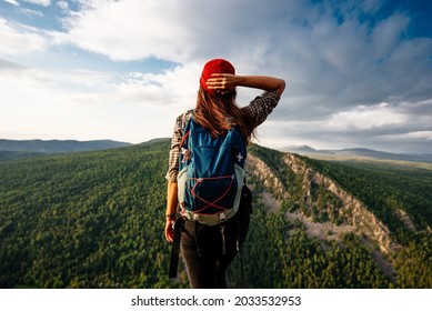 A woman is traveling in Bashkiria, Russia. Mountain tourism in Russia. Walking tour of the mountains of Bashkiria, Aigir. A trip to the mountains with a backpack. Copy space